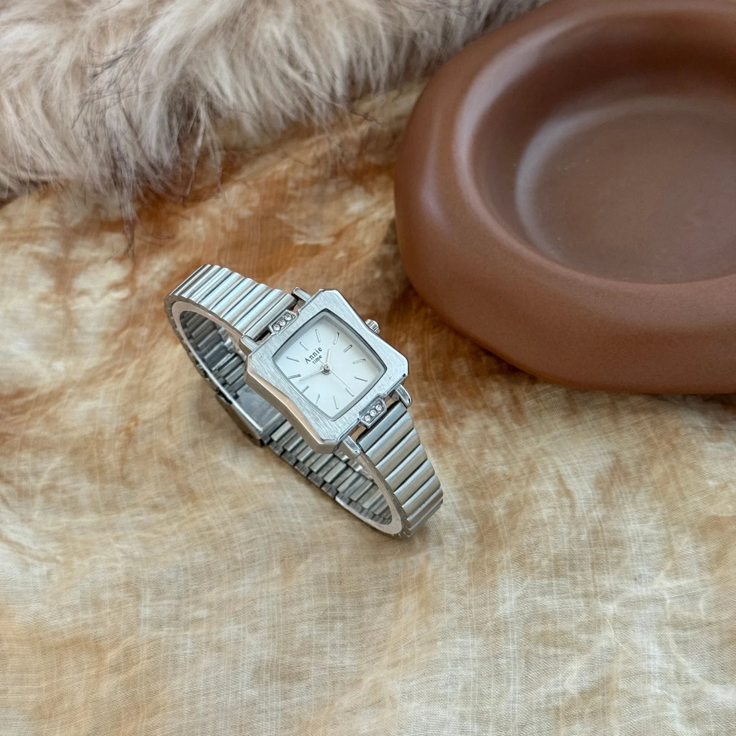 Montre élégante et simple, avec bracelet en acier inoxydable doré et réglable. Cadran carré raffiné.