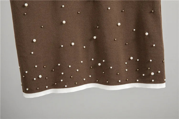 Ensemble tricoté deux pièces pull et longue jupe en maille.